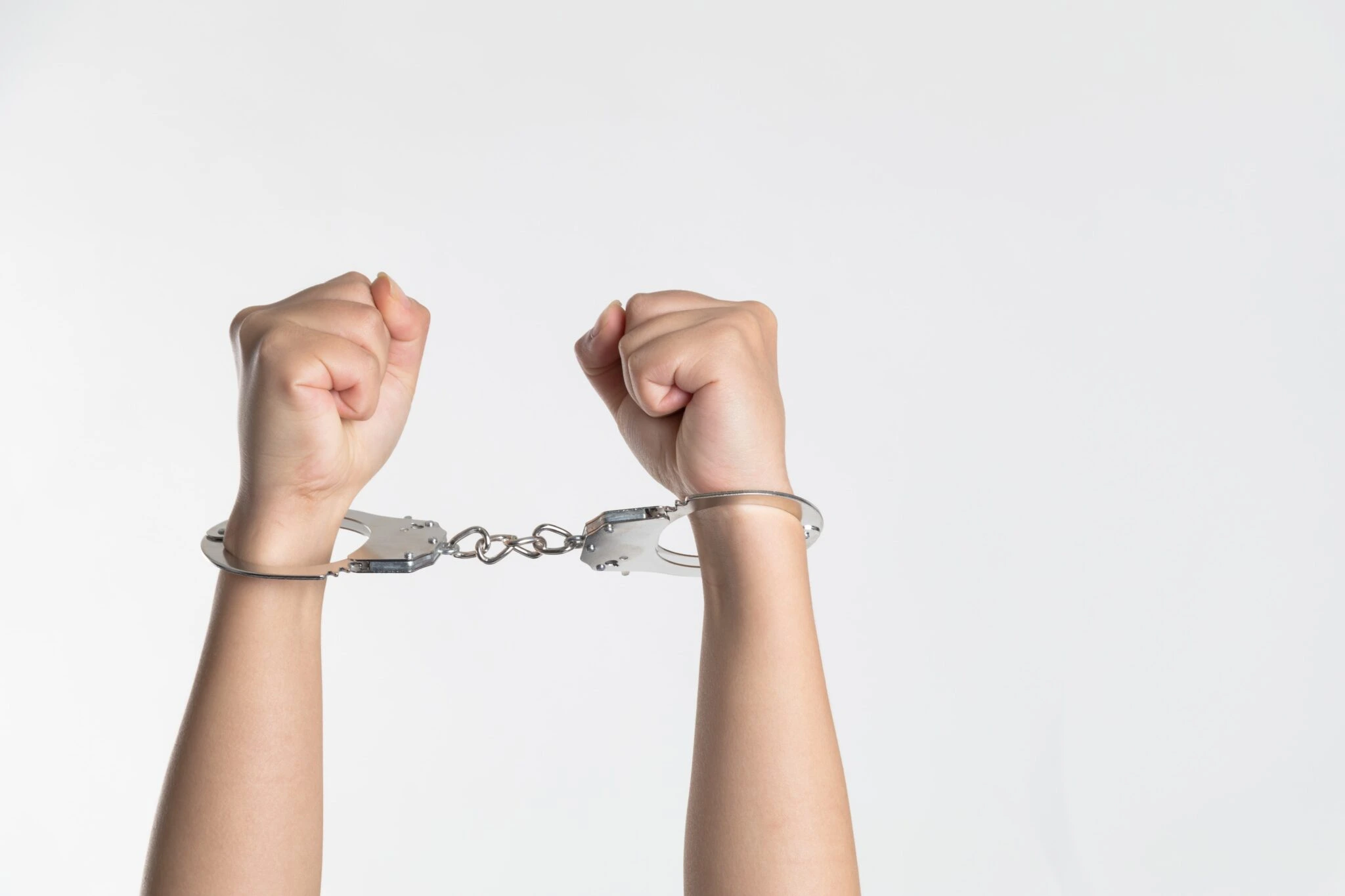 Two arms that are in handcuffs